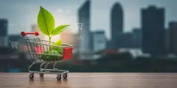 Green leaf sprouting from a shopping cart, symbolizing sustainable e-commerce growth